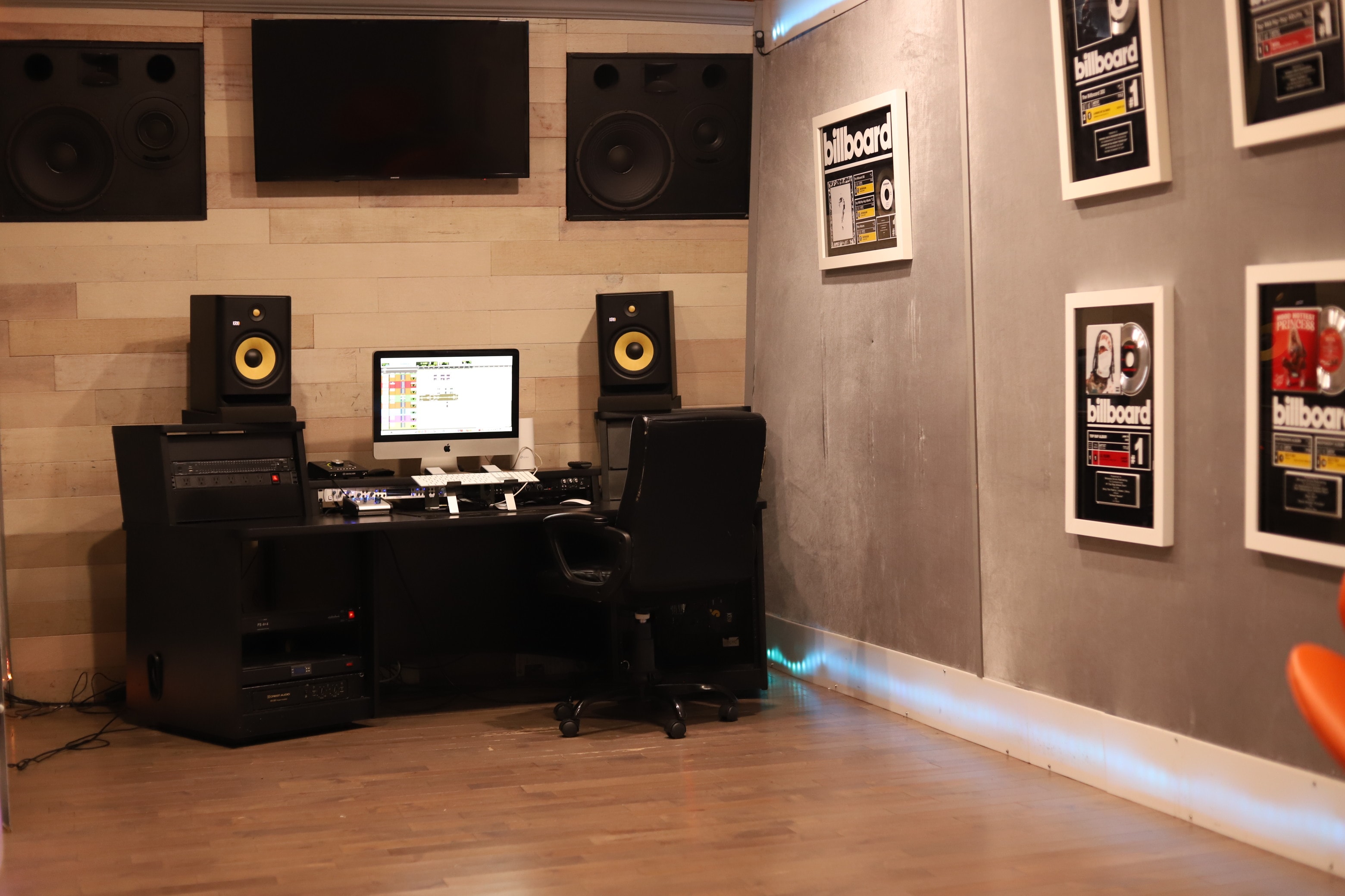 Billboard Room — wide room shot with Billboard plaques, KRK monitors, and iMac