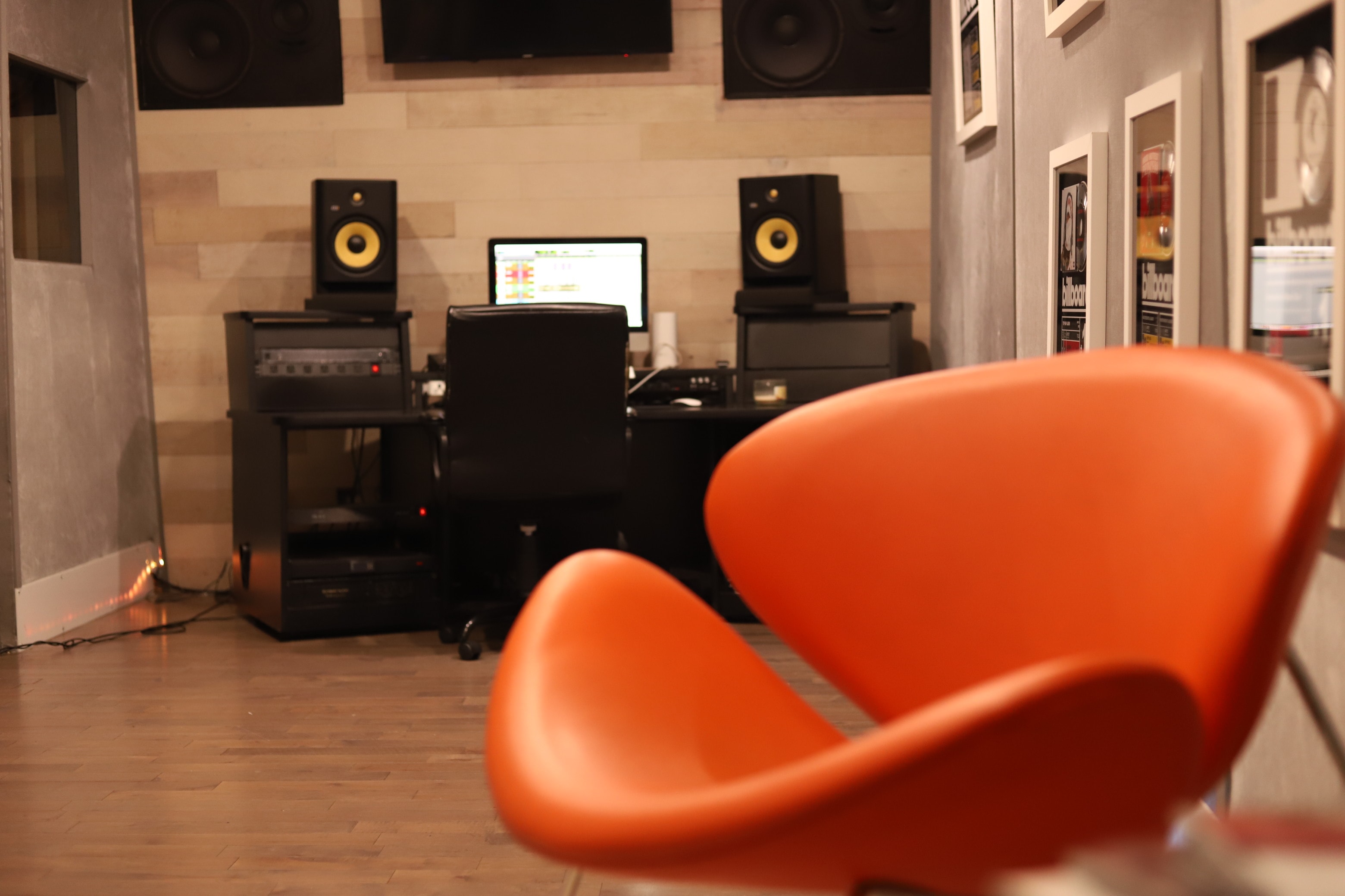 Billboard Room — KRK monitor with vocal booth window and mic in background