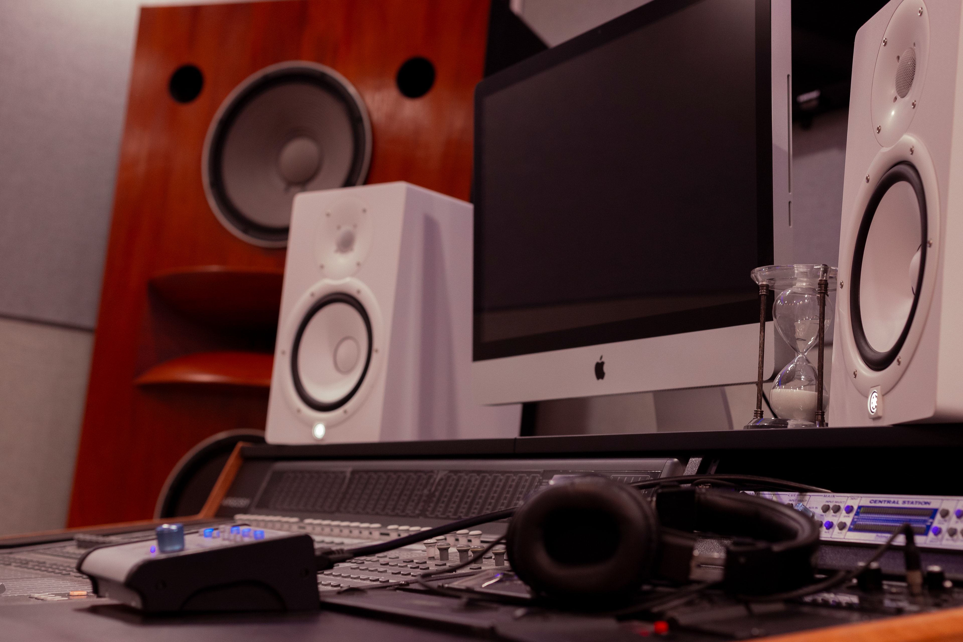 Grammy Room — wide shot with large orange speakers, white Yamaha monitors, and analog console
